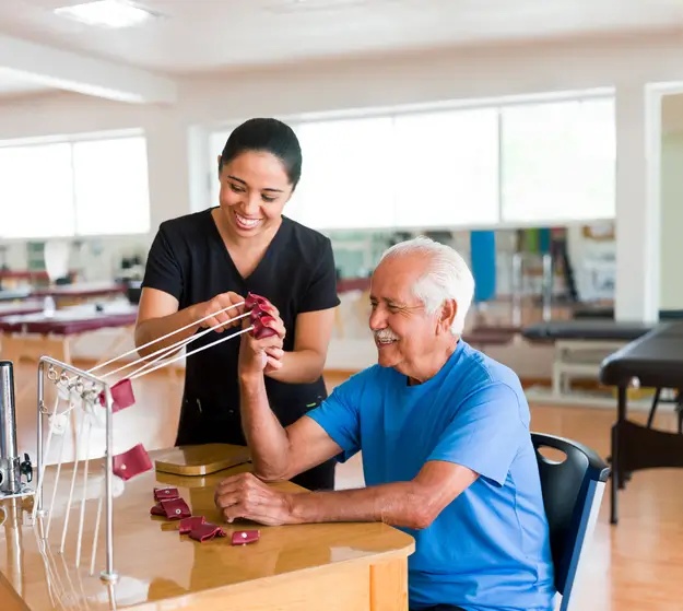 A senior man exercising with the assistance of a physical therapist in Bossier City, LA