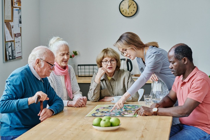 A group of seniors playing a board game in dementia care in Bossier City, LA