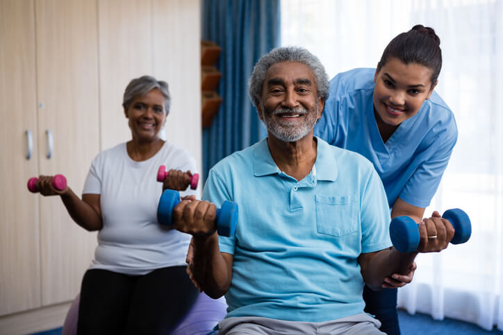 A senior man and woman with a nurse for occupational therapy at a skilled nursing facility in Bossier City, LA