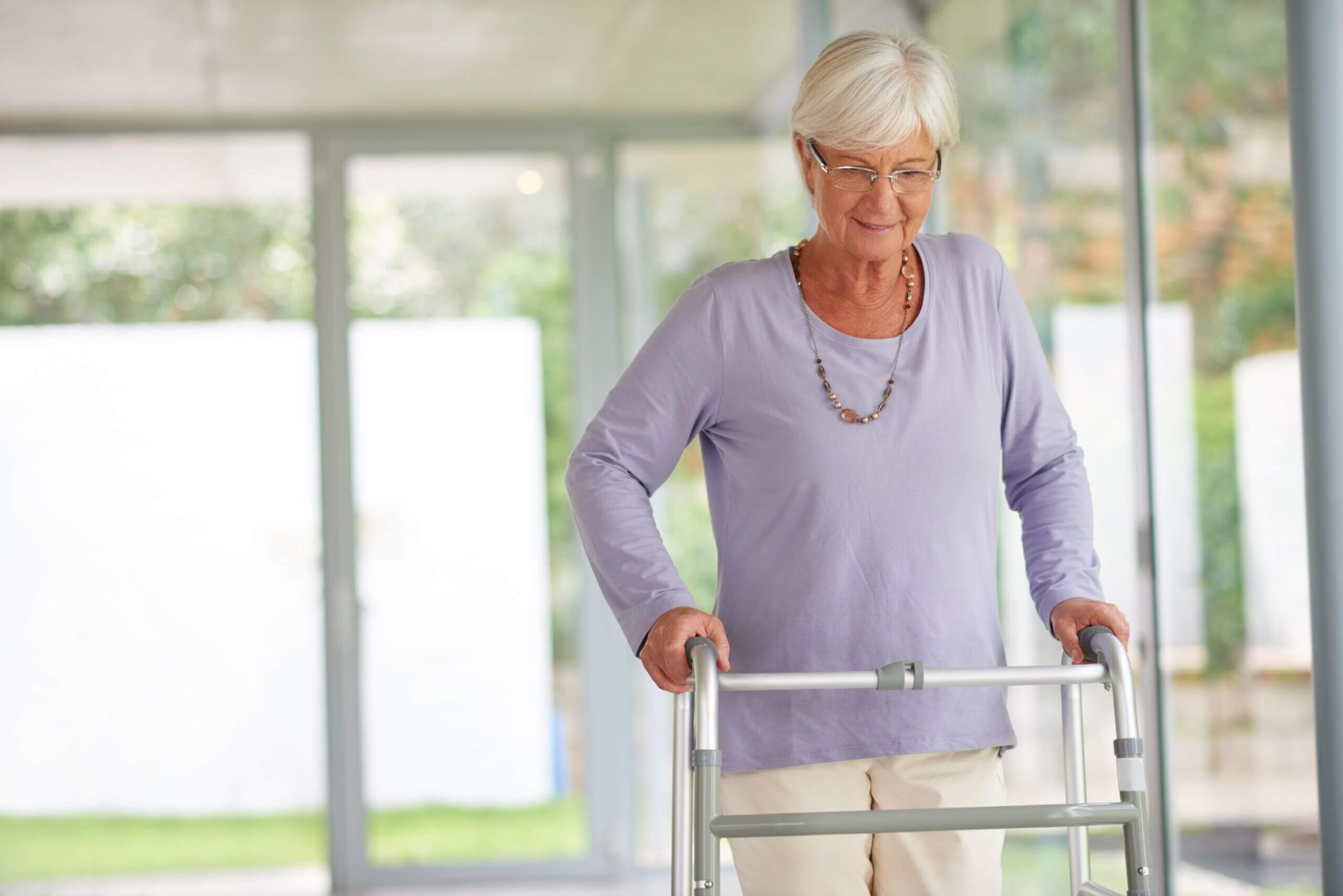 Elderly woman using a walker for Post-Surgery Care and mobility support in a skilled nursing facility in Bossier City, LA